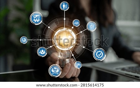 This image presents a lightbulb surrounded by various icons, symbolizing innovative business strategies, technology, and growth in a modern office setting. Crux