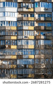 This image presents a vibrant and visually stunning view of a multicolored apartment building facade that showcases a diverse array of unique balcony designs along with various window styles