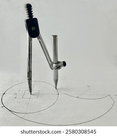 This image represents a drawing tool called a mathematical compass, featuring a simple design capable of creating graceful curves and freely drawn lines. It offers versatility in its applications.