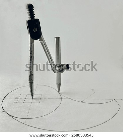 This image represents a drawing tool called a mathematical compass, featuring a simple design capable of creating graceful curves and freely drawn lines. It offers versatility in its applications.