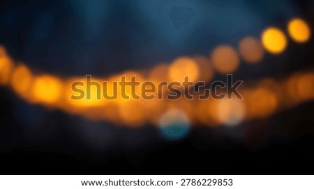 This image showcases an abstract bokeh effect with vibrant, blurred lights. The warm, golden orbs create a dreamy atmosphere against a dark background, perfect for artistic projects.