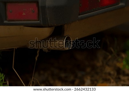 This image showcases a closeup view of the exhaust pipe of a car, highlighting its details and design intricacies