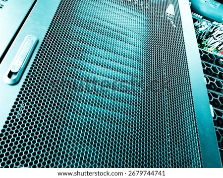 This image showcases a close-up view of a black metal grate featuring a honeycomb pattern. Ideal for backgrounds, textures, or design projects.