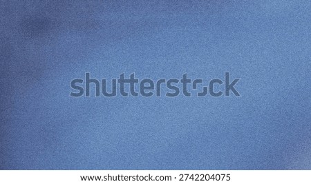 This image showcases a close-up view of a textured blue fabric. The fabric exhibits a subtle gradient effect, transitioning from a lighter shade of blue at the top to a slightly darker shade at the bottom. The texture of the fabric is visible, adding depth and dimension to the image.