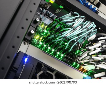 This image showcases a detailed view of a server rack filled with network cables. LED indicators light up various connections, emphasizing modern data center technology.