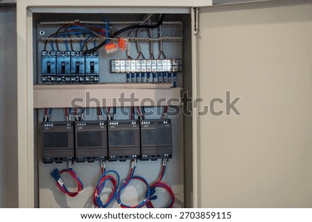 This image showcases an electrical control panel featuring organized wiring and connections. Ideal for showcasing automation technology and engineering solutions.