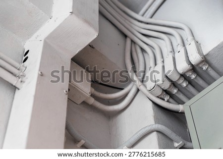 This image showcases a network of electrical conduits and cables installed in a building, highlighting modern wiring organization and electrical infrastructure setup.