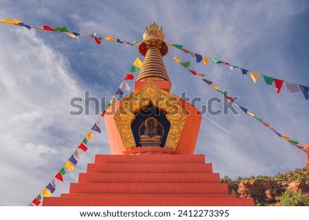 This image shows an authentic buddhist stupa with a calm blue sky in the background. 