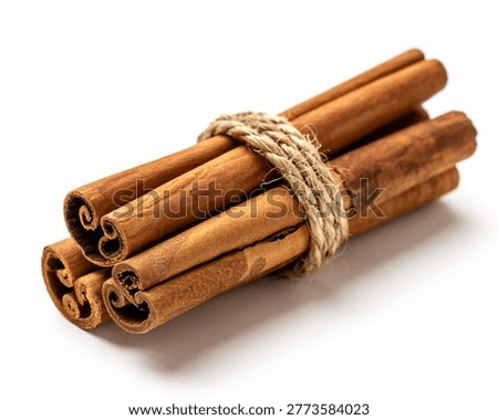 This image shows a bundle of cinnamon sticks tied together with a piece of twine. The cinnamon sticks are brown and have a natural, organic look. They are curled and rolled, showcasing their unique texture. The background is plain white, which highlights the details of the cinnamon sticks. The image appears to be a product photo, likely used for culinary or baking purposes.