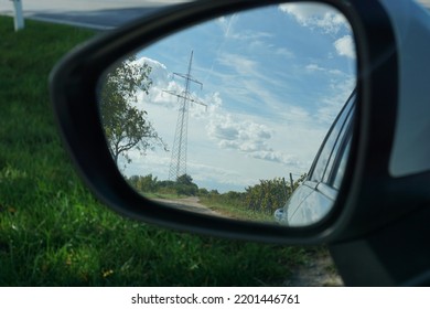 This Image Shows A Car Mirror With Country Side Reflection.