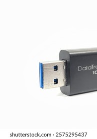 This image shows a close-up view of a USB flash drive,specifically the USB connector part.The connector is metallic with a blue plastic insert,indicating it is a USB 3.0 type.This flash drive is black