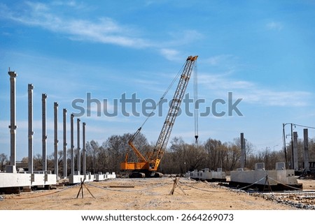 This image shows a construction site with a large crane in the center