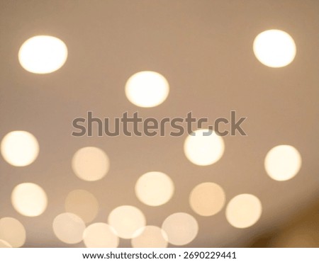 This image shows diffused glowing lights creating an abstract and elegant pattern, soft luminosity and blurred effect.