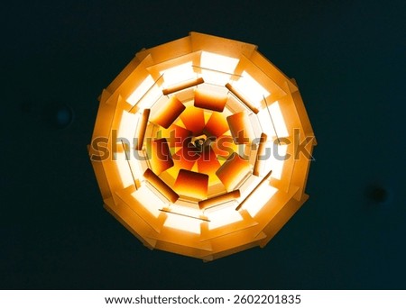 This image shows a low-angle view of a decorative, multi-faceted lamp fixture.