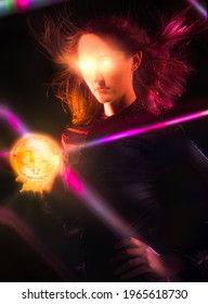 This image shows a powerful young woman holding a glowing crypto currency Bitcoin in her palm as her eyes beam lasers into a dark room. 