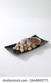 This image shows a small ceramic or wooden bowl filled with mixed snacks, photographed from above.