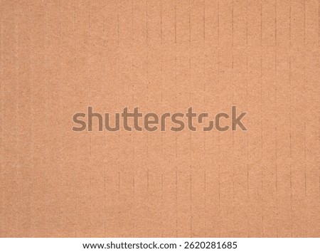 This image shows the surface of brown corrugated cardboard used for packaging boxes.
The vertical lines indicate the structure that adds strength and supports compression.

