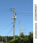 This image shows a typical utility pole in a Japanese town
with a huge steel tower in the background
for distributing super high voltage to a remote area.
