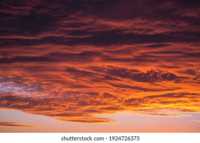 This Image Shows A Vast Sunset Sky Filled With Large Clouds. 