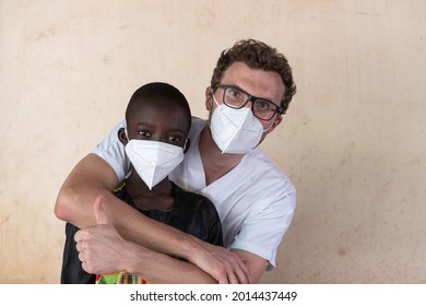 In This Image A White Doctor Volunteering In An African Hospital Is Hugging A Small Black Boy And Thumb Up Sign After Having Successfully Completed A Full Body Health Check Up.