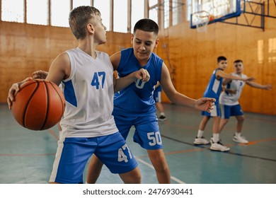 In this image, young kids are engaged in a competitive basketball match, displaying skills and teamwork in the sport, passing the ball - Powered by Shutterstock