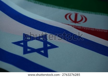 This image zeroes in on the flags of Israel and Iran, representing their complex and often adversarial relationship in the Middle East, a subject of ongoing global concern.