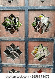 This imposing iron gate commands attention with its robust structure adorned by intricate geometric star patterns. The interplay of forged metal bars and delicate stellar between might and artistry
