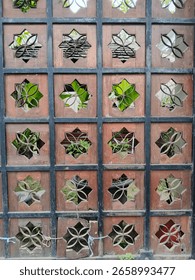 This imposing iron gate commands attention with its robust structure adorned by intricate geometric star patterns. The interplay of forged metal bars and delicate stellar between might and artistry