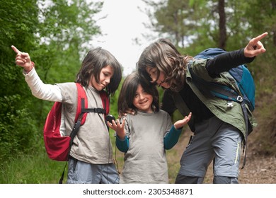 In this intriguing image, three siblings are consulting a compass. The youngest sibling, with a surprised expression, holds the compass while the other two point to two different paths. 