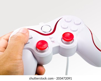 This is a joystick in the hand on gradient tone background