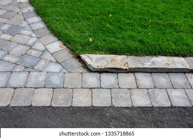 This Landscape Project Shows A Professionally Designed And Crafted Transition From Walkway To Driveway, And Uses Natural Stone Curbing To Minimize The Grade Between Lawn And Pavers.