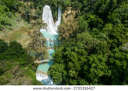 This location features multiple waterfalls flowing into a turquoise pool. Visitors can explore the natural beauty and dense tropical vegetation in Huasteca Potosina, San Luis Potosi, Mexico.