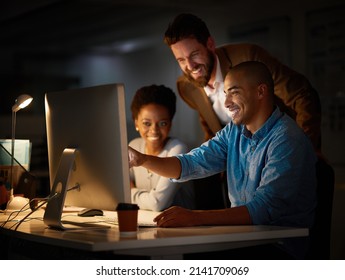 This Looks Like Our Best Choice.... Cropped Shot Of A Group Of Colleagues Working Late In An Office.