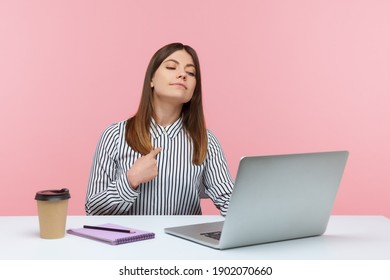 This Is Me! Self Confident Egoistic Business Woman Pointing Herself And Looking At Laptop Display With Arrogant Expression, Working In Office. Indoor Studio Shot Isolated On Pink Background