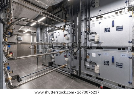 This mechanical room features multiple units for heating and cooling, showcasing advanced technology and efficient piping systems designed for a commercial environment