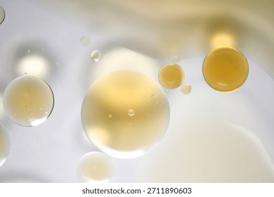 This mesmerizing abstract image features a colorful mixture of oil and water droplets. The interplay of light and bubbles creates a serene and modern aesthetic.