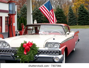 this is a mid 1950s car at a gasoline service station with a wreath on the front of the grill. - Powered by Shutterstock