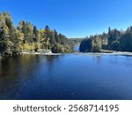 This is mid-day overlooking the main waterfall of Kakabeka Falls just before the fall colors! The trees make for a majestic backdrop against the deep blue water and sky.