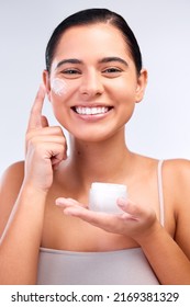 This Moisturiser Leaves My Skin Hydrated And Smooth. Shot Of A Beautiful Young Woman Applying Moisturiser To Her Face.