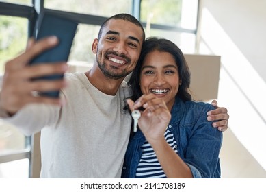 This is a moment worth capturing. Shot of a happy young couple taking a selfie while moving into their new house together. - Powered by Shutterstock