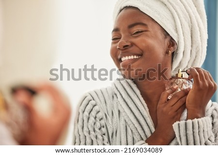 This is my favourite fragrance. Shot of a young woman looking cheerful while using perfume.