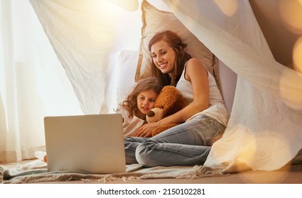 This Is My Favourite Part. Shot Of A Mother And Daughter Bonding And Watching A Movie On A Laptop In The Bedroom.