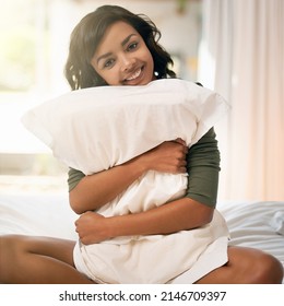 This Is My Kinda Weekend. Shot Of A Young Woman Hugging Her Pillow While Sitting On Her Bed.