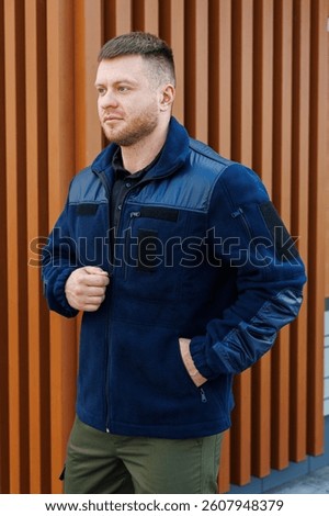 This navy jacket provides both comfort and style, featuring practical pockets and crafted from highquality materials, making it an ideal choice for various outdoor activities