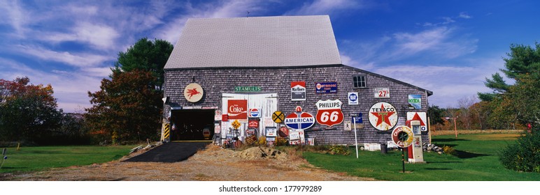 This Is A New England Barn With Numerous Signs Posted On The Outside Of It. The Signs Are Old Advertising Signs From Various Oil Companies, As Well As Marlboro.