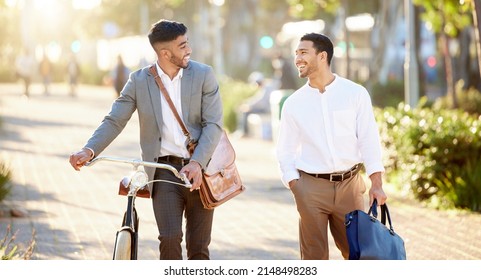 This Is Our Time To Catch Up. Shot Of Two Young Businessmen Walking Through The City Together During Their Afternoon Commute From The Office.