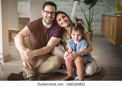 This Is Our Time. Parents With Daughter At Home. 