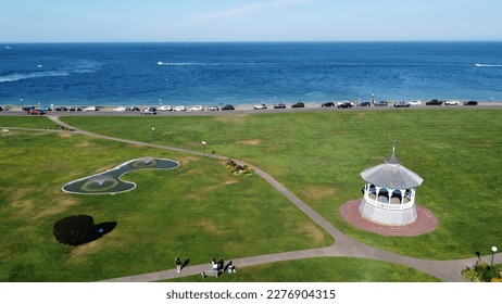 This pack of photos showcases the picturesque Oak Bluffs Ocean Park on the Island of Martha's Vineyard. The photos capture the park's natural beauty, including its lush green grass, towering trees, ro - Shutterstock ID 2276904315