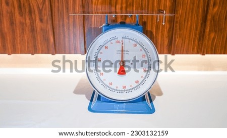 This particular weight scale has a capacity of up to 100 kilograms and is colored in blue, making it easy to identify.