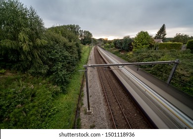 This passing train drives through a beautiful piece of nature